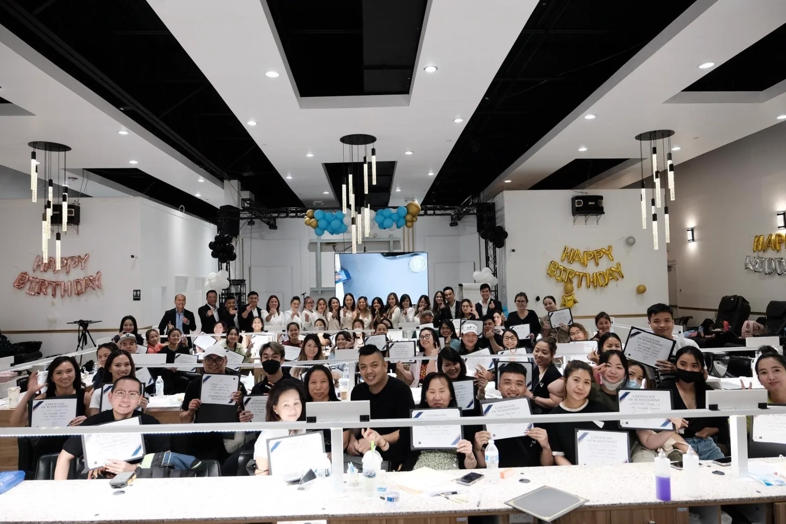Group of students holding certificates at the end of a class